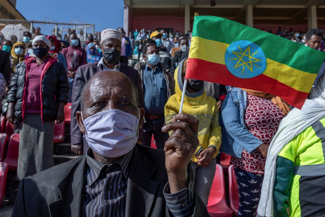 A man holds a national flag as he waits in the stands to give blood at a blood drive in support of the country's military, at a stadium in the capital Addis Ababa, Ethiopia Thursday, Nov. 12, 2020. Rallies occurred in multiple cities in support of the federal government's military offensive against the Tigray regional government, the Tigray People's Liberation Front. (AP Photo/Mulugeta Ayene) A man holds a national flag as he waits in the stands to give blood at a blood drive in support of the country's military, at a stadium in the capital Addis Ababa, Ethiopia Thursday, Nov. 12, 2020. Rallies occurred in multiple cities in support of the federal government's military offensive against the Tigray regional government, the Tigray People's Liberation Front. (AP Photo/Mulugeta Ayene)