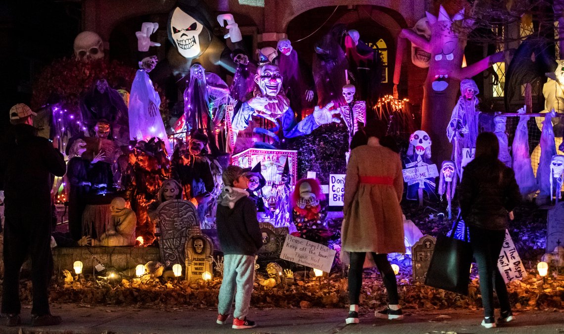 People take in the decorations outside a home on Halloween night in Ottawa, Ontario, Saturday, Oct. 31, 2020. (Justin Tang/The Canadian Press via AP) People take in the decorations outside a home on Halloween night in Ottawa, Ontario, Saturday, Oct. 31, 2020. (Justin Tang/The Canadian Press via AP)