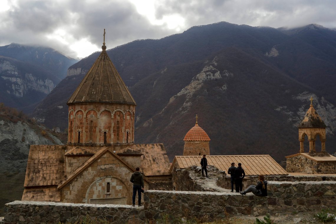Armenians visit the 12th-13th century Orthodox Dadivank Monastery on the outskirts of Kalbajar, the separatist region of Nagorno-Karabakh, on Friday, Nov. 13, 2020. Under an agreement ending weeks of intense fighting over Nagorno-Karabakh, some Armenian-held territories, such as this area, will pass to Azerbaijan. (AP Photo/Sergei Grits) Armenians visit the 12th-13th century Orthodox Dadivank Monastery on the outskirts of Kalbajar, the separatist region of Nagorno-Karabakh, on Friday, Nov. 13, 2020. Under an agreement ending weeks of intense fighting over Nagorno-Karabakh, some Armenian-held territories, such as this area, will pass to Azerbaijan. (AP Photo/Sergei Grits)