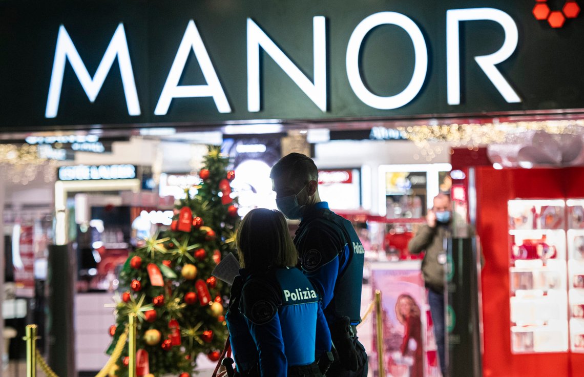 Police walk near the area where a stabbing occurred in a department store, in Lugano, Switzerland, Tuesday, Nov. 24, 2020. Swiss authorities are investigating as a possible terror attack the stabbing of two women in an department store in the southern city of Lugano, and a suspect has been arrested. Officials said one of the victims sustained serious but not life-threatening injuries, while the other sustained minor injuries. (Ti-Press/Keystone via AP) Police walk near the area where a stabbing occurred in a department store, in Lugano, Switzerland, Tuesday, Nov. 24, 2020. Swiss authorities are investigating as a possible terror attack the stabbing of two women in an department store in the southern city of Lugano, and a suspect has been arrested. Officials said one of the victims sustained serious but not life-threatening injuries, while the other sustained minor injuries. (Ti-Press/Keystone via AP)