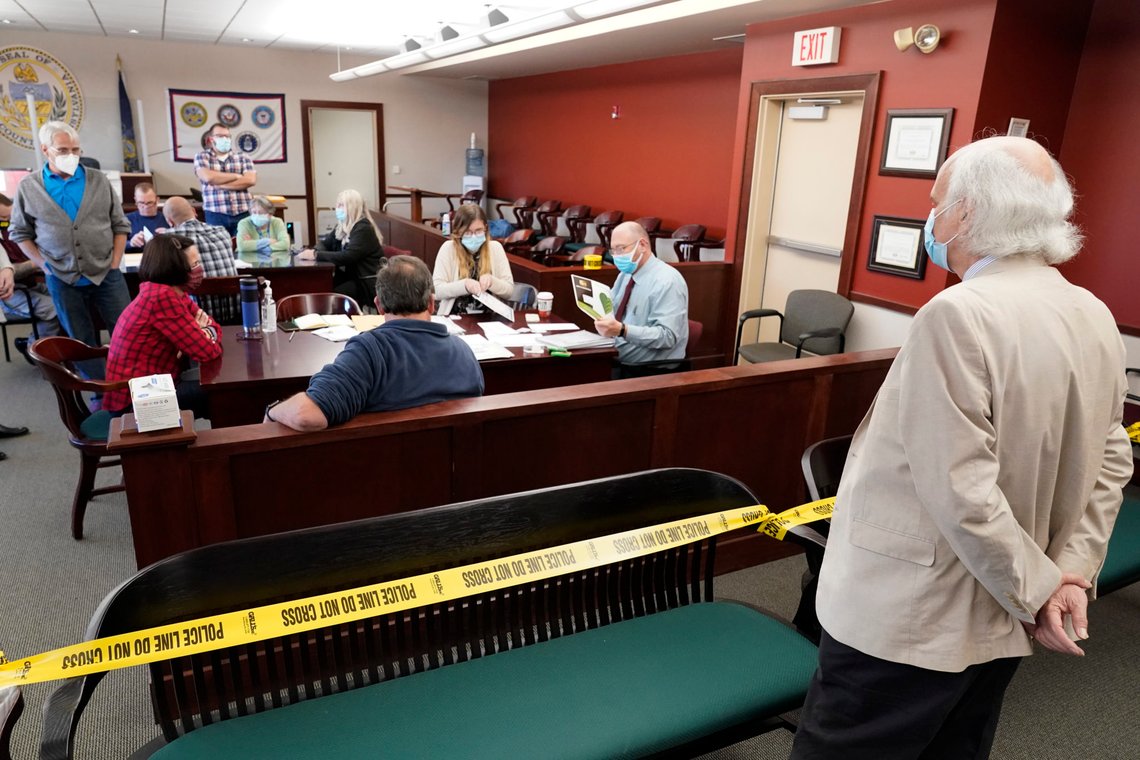 An observer watches as Luzerne County workers canvas ballots that arrived after closing of voting until Friday at 5pm and postmarked by Nov. 3rd as vote counting in the general election continues, Friday, Nov. 6, 2020, in Wilkes-Barre, Pa. (AP Photo/Mary Altaffer) An observer watches as Luzerne County workers canvas ballots that arrived after closing of voting until Friday at 5pm and postmarked by Nov. 3rd as vote counting in the general election continues, Friday, Nov. 6, 2020, in Wilkes-Barre, Pa. (AP Photo/Mary Altaffer)