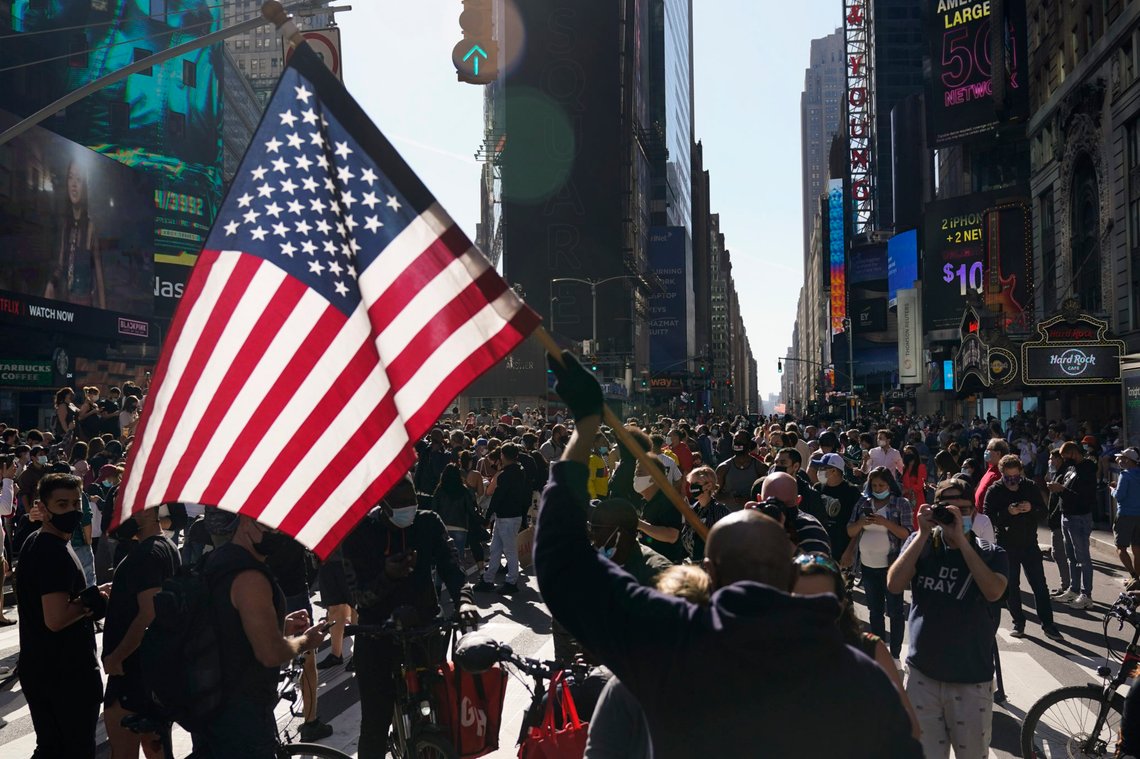 People celebrate in Times Square after former vice president and Democratic presidential candidate Joe Biden was announced as the winner over Pres. Donald Trump to become the 46th president of the United States, Saturday, Nov. 7, 2020, in New York. His victory came after more than three days of uncertainty as election officials sorted through a surge of mail-in votes that delayed the processing of some ballots. (AP Photo/Seth Wenig) People celebrate in Times Square after former vice president and Democratic presidential candidate Joe Biden was announced as the winner over Pres. Donald Trump to become the 46th president of the United States, Saturday, Nov. 7, 2020, in New York. His victory came after more than three days of uncertainty as election officials sorted through a surge of mail-in votes that delayed the processing of some ballots. (AP Photo/Seth Wenig)