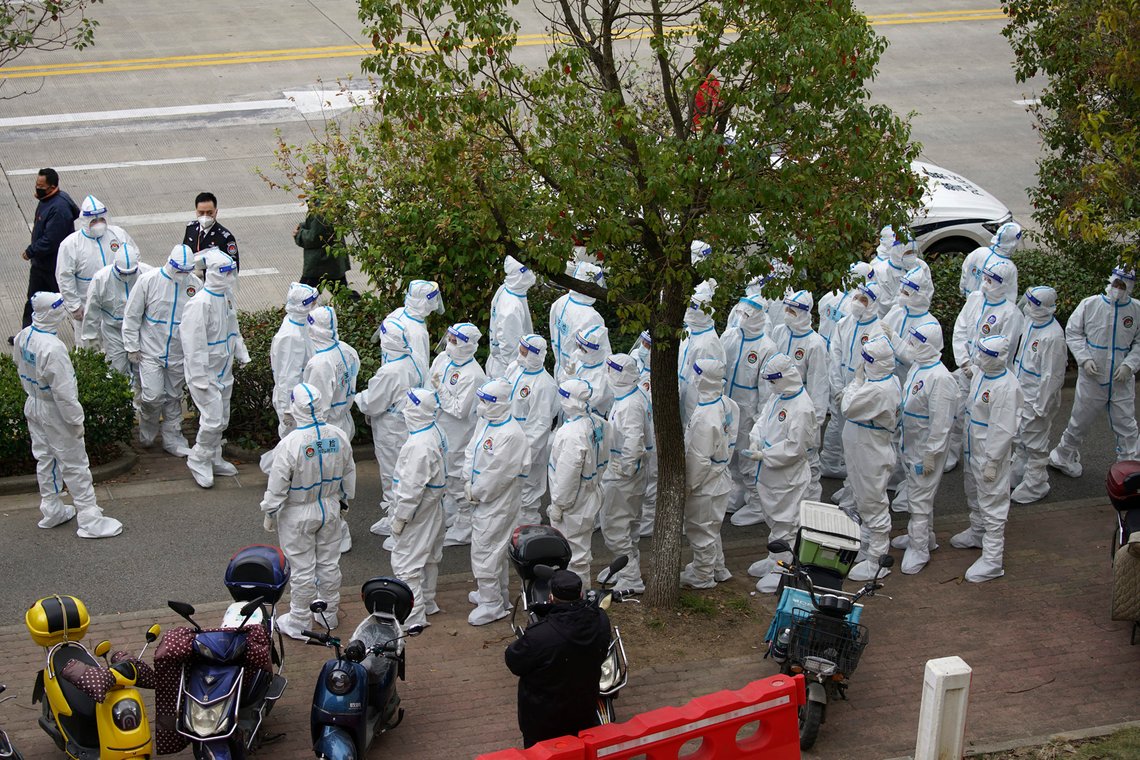 Security workers in protective suit prepare for administering COVID-19 testings for workers at the parking lot of the Shanghai Pudong International Airport in Shanghai, Monday, Nov. 23, 2020. Chinese authorities are testing millions of people, imposing lockdowns and shutting down schools after multiple locally transmitted coronavirus cases were discovered in three cities across the country last week. (AP Photo) Security workers in protective suit prepare for administering COVID-19 testings for workers at the parking lot of the Shanghai Pudong International Airport in Shanghai, Monday, Nov. 23, 2020. Chinese authorities are testing millions of people, imposing lockdowns and shutting down schools after multiple locally transmitted coronavirus cases were discovered in three cities across the country last week. (AP Photo)
