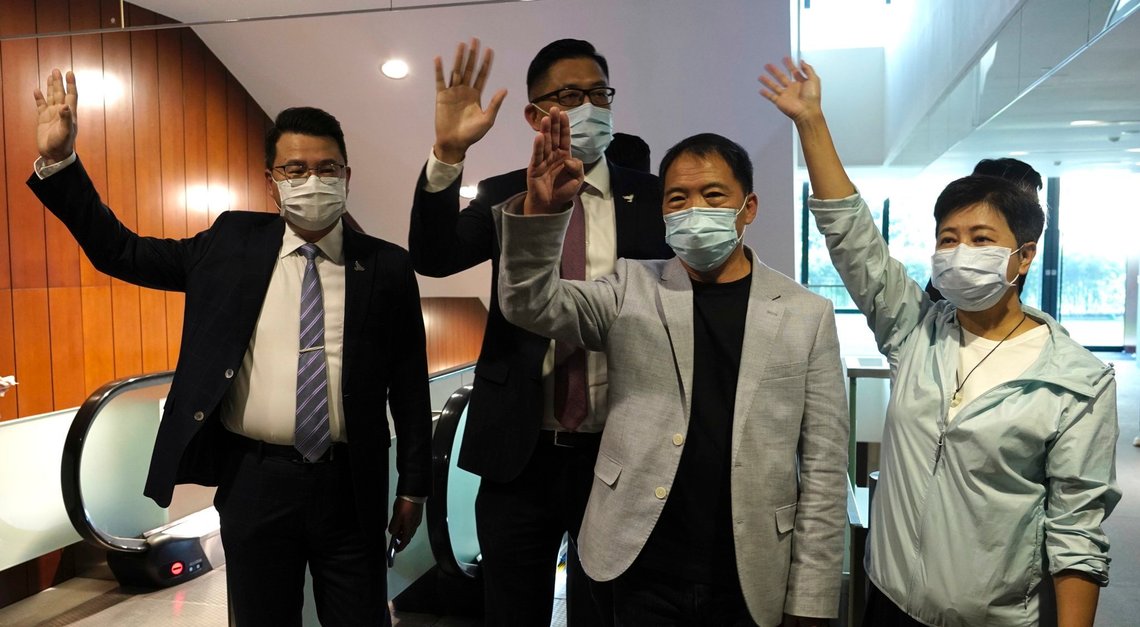 Pro-democracy legislators, from right, Wong Pik Wan, Wu Chi Wai, Lam Cheuk-ting, Yoon Siu Kin wave after handing their letters at Legislative Council in Hong Kong, Thursday day, Nov. 12, 2020. Hong Kong's pro-democracy lawmakers have handed in their resignations following a move by the city's government to disqualify four pro-democracy legislators. (AP Photo/Vincent Yu) Pro-democracy legislators, from right, Wong Pik Wan, Wu Chi Wai, Lam Cheuk-ting, Yoon Siu Kin wave after handing their letters at Legislative Council in Hong Kong, Thursday day, Nov. 12, 2020. Hong Kong's pro-democracy lawmakers have handed in their resignations following a move by the city's government to disqualify four pro-democracy legislators. (AP Photo/Vincent Yu)