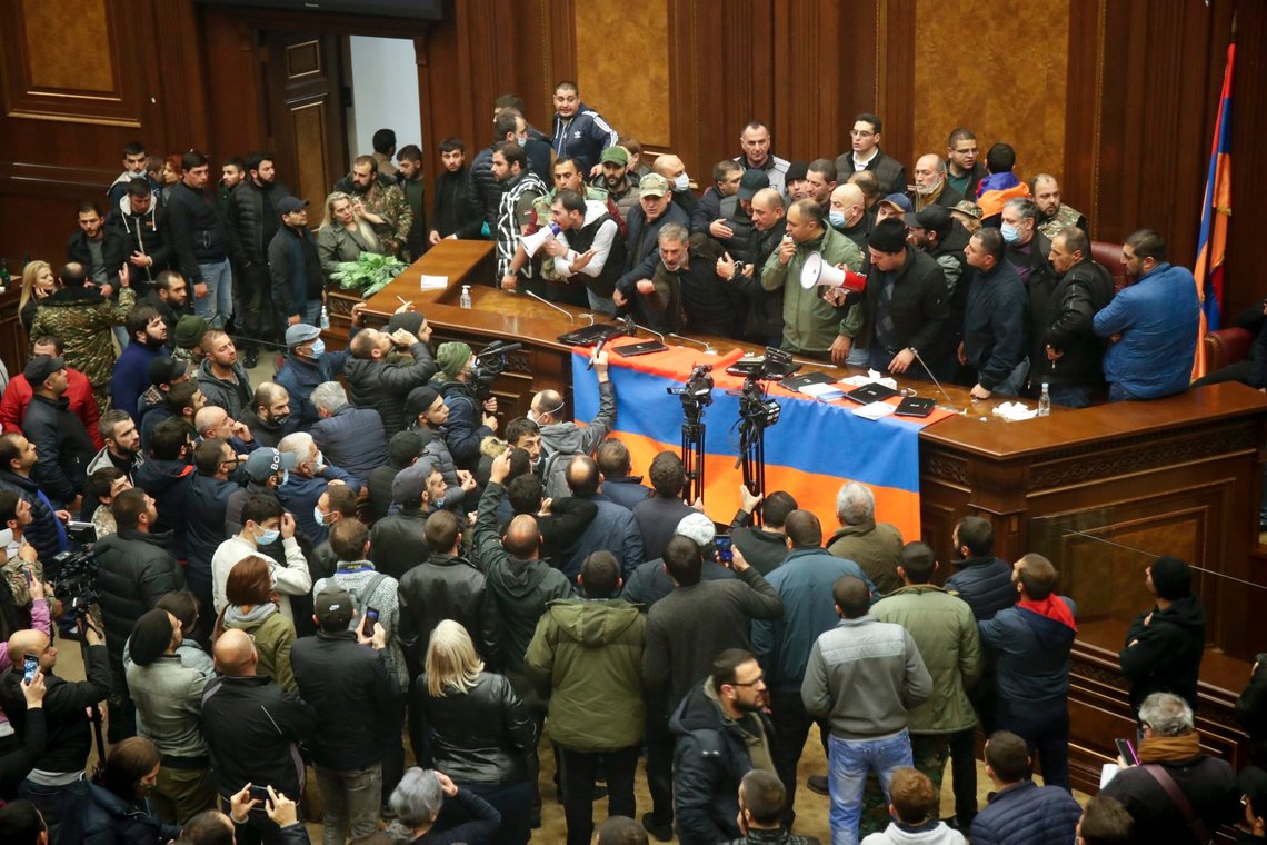 People shout as they broke into the parliamentary building protesting against an agreement to halt fighting over the Nagorno-Karabakh region, in Yerevan, Armenia, Tuesday, Nov. 10, 2020. Armenian Prime Minister Nikol Pashinian said on Facebook that calling an end to the fight was "extremely painful for me personally and for our people." Soon after the announcement, thousands of people streamed to the main square in the Armenian capital Yerevan to protest the agreement, many shouting "We won't give up our land." Some of them broke into the main government building, saying they were searching for Pashinian, who apparently had already departed. (AP Photo/Dmitri Lovetsky) People shout as they broke into the parliamentary building protesting against an agreement to halt fighting over the Nagorno-Karabakh region, in Yerevan, Armenia, Tuesday, Nov. 10, 2020. Armenian Prime Minister Nikol Pashinian said on Facebook that calling an end to the fight was "extremely painful for me personally and for our people." Soon after the announcement, thousands of people streamed to the main square in the Armenian capital Yerevan to protest the agreement, many shouting "We won't give up our land." Some of them broke into the main government building, saying they were searching for Pashinian, who apparently had already departed. (AP Photo/Dmitri Lovetsky)