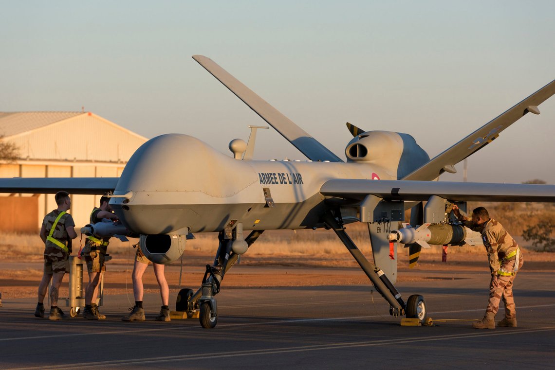 This photo provided by the French Defense Ministry communication center and taken Tuesday Dec. 17, 2019, shows French soldiers loading a French Reaper drone with two GBU 12 missiles on Niamey airbase, Niger. France's defense ministry said Monday that it had carried out its first armed drone strike, killing seven Islamic extremists in central Mali over the weekend. France joins a tiny group of countries that use armed drones, including the United States. (Malaury Buis/EMA/DICOD via AP) This photo provided by the French Defense Ministry communication center and taken Tuesday Dec. 17, 2019, shows French soldiers loading a French Reaper drone with two GBU 12 missiles on Niamey airbase, Niger. France's defense ministry said Monday that it had carried out its first armed drone strike, killing seven Islamic extremists in central Mali over the weekend. France joins a tiny group of countries that use armed drones, including the United States. (Malaury Buis/EMA/DICOD via AP)