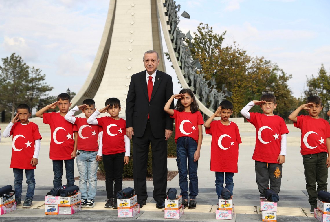 Turkish President Recep Tayyip Erdogan poses for photos with primary school students from a village of Black Sea city of Samsun, who give a military style salute outside the presidential palace, in Ankara Monday, Oct. 21, 2019. Erdogan has responded angrily to widespread criticism in the West of Turkey's incursion in northeast Syria.(Presidential Press Service via AP, Pool ) Turkish President Recep Tayyip Erdogan poses for photos with primary school students from a village of Black Sea city of Samsun, who give a military style salute outside the presidential palace, in Ankara Monday, Oct. 21, 2019. Erdogan has responded angrily to widespread criticism in the West of Turkey's incursion in northeast Syria.(Presidential Press Service via AP, Pool )