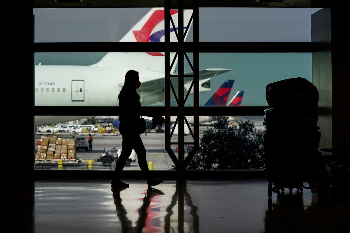 A traveler with a face mask is silhouetted next to her luggage at the Los Angeles International Airport in Los Angeles, Monday, Nov. 23, 2020. About 1 million Americans a day packed airports and planes over the weekend even as coronavirus deaths surged across the U.S. and public health experts begged people to stay home and avoid big Thanksgiving gatherings. (AP Photo/Jae C. Hong) A traveler with a face mask is silhouetted next to her luggage at the Los Angeles International Airport in Los Angeles, Monday, Nov. 23, 2020. About 1 million Americans a day packed airports and planes over the weekend even as coronavirus deaths surged across the U.S. and public health experts begged people to stay home and avoid big Thanksgiving gatherings. (AP Photo/Jae C. Hong)