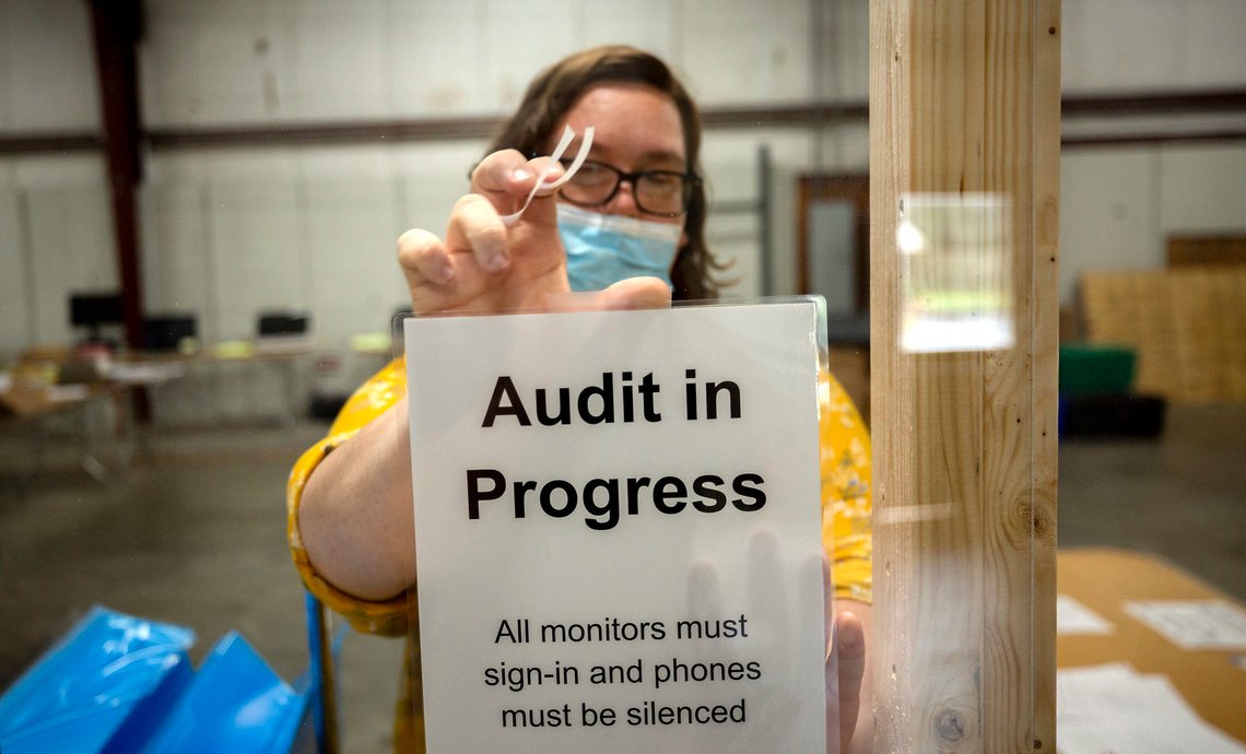 A Chatham County election official posts a sign in the public viewing area before the start of a ballot audit, Friday, Nov. 13, 2020, in Savannah, Ga. Election officials in Georgias 159 counties are undertaking a hand tally of the presidential race that stems from an audit required by state law. (AP Photo/Stephen B. Morton) A Chatham County election official posts a sign in the public viewing area before the start of a ballot audit, Friday, Nov. 13, 2020, in Savannah, Ga. Election officials in Georgias 159 counties are undertaking a hand tally of the presidential race that stems from an audit required by state law. (AP Photo/Stephen B. Morton)