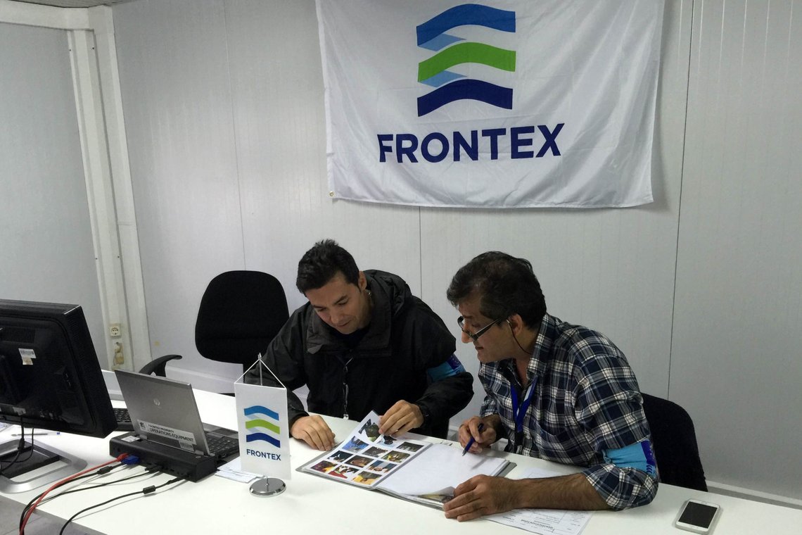 In this photo taken on Saturday, Oct. 31, 2015, Frontex officer Francisco Ramos, left, and a colleague review data at a registration center run by the EU border protection agency at Moria on the island of Lesbos in southeastern Greece. The pilot program on Lesbos is aimed at speeding up registration of migrants and refugees amid a surge in the daily arrivals on Greek Islands. (AP Photo/Derek Gatopoulos) In this photo taken on Saturday, Oct. 31, 2015, Frontex officer Francisco Ramos, left, and a colleague review data at a registration center run by the EU border protection agency at Moria on the island of Lesbos in southeastern Greece. The pilot program on Lesbos is aimed at speeding up registration of migrants and refugees amid a surge in the daily arrivals on Greek Islands. (AP Photo/Derek Gatopoulos)
