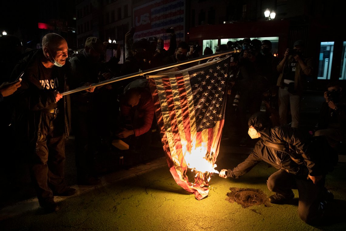 Protesters burn a national flag during a march following the presidential election Wednesday, Nov. 4, 2020, in Portland, Ore. (AP Photo/Paula Bronstein) Protesters burn a national flag during a march following the presidential election Wednesday, Nov. 4, 2020, in Portland, Ore. (AP Photo/Paula Bronstein)