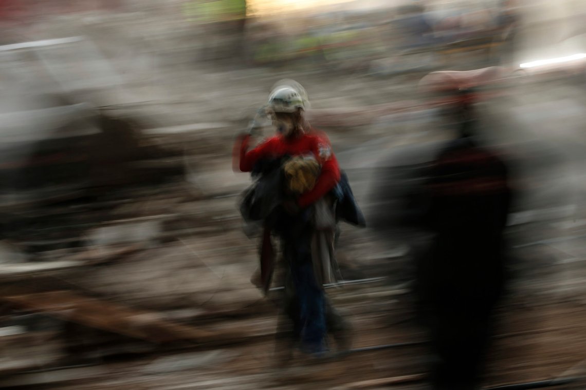 In this photo made with a slow shutter speed, members of rescue services work in the debris of a collapsed building, in Izmir, Turkey, Monday, Nov. 2, 2020, after the region was jolted by quake that killed scores of people. Close to a thousand were injured. (AP Photo/Emrah Gurel) In this photo made with a slow shutter speed, members of rescue services work in the debris of a collapsed building, in Izmir, Turkey, Monday, Nov. 2, 2020, after the region was jolted by quake that killed scores of people. Close to a thousand were injured. (AP Photo/Emrah Gurel)