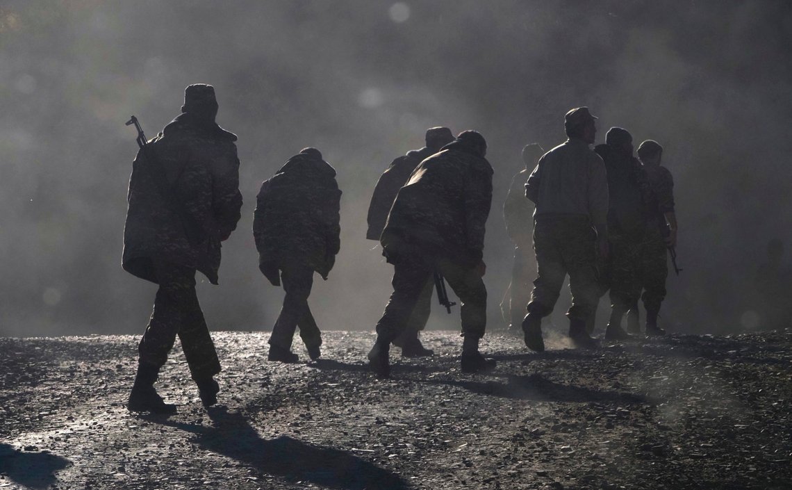 Ethnic Armenian soldiers walk along the road near the border between Nagorno-Karabakh and Armenia, Sunday, Nov. 8, 2020. Azerbaijan's president says forces have taken control of the strategically key city of Shushi in Nagorno-Karabakh, but a Armenian Defense Ministry spokesman said on Facebook that "fighting in Shushi is continuing." Nagorno-Karabakh lies within Azerbaijan but has been under control of ethnic Armenian forces backed by Armenia since a separatist war there ended in 1994. (AP Photo) Ethnic Armenian soldiers walk along the road near the border between Nagorno-Karabakh and Armenia, Sunday, Nov. 8, 2020. Azerbaijan's president says forces have taken control of the strategically key city of Shushi in Nagorno-Karabakh, but a Armenian Defense Ministry spokesman said on Facebook that "fighting in Shushi is continuing." Nagorno-Karabakh lies within Azerbaijan but has been under control of ethnic Armenian forces backed by Armenia since a separatist war there ended in 1994. (AP Photo)