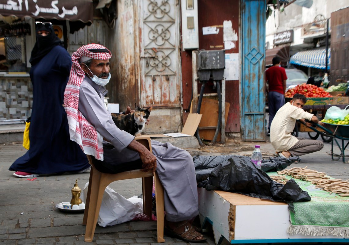 A Saudi vendor wearing a face mask to help curb the spread of the coronavirus, carries his cat as he sells "Miswak", a natural herbal toothbrush, at Jiddah old city, Saudi Arabia, Thursday, Dec. 17, 2020. (AP Photo/Amr Nabil) A Saudi vendor wearing a face mask to help curb the spread of the coronavirus, carries his cat as he sells "Miswak", a natural herbal toothbrush, at Jiddah old city, Saudi Arabia, Thursday, Dec. 17, 2020. (AP Photo/Amr Nabil)