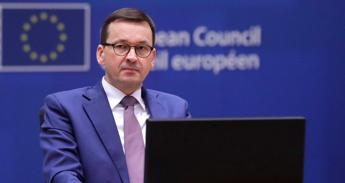 Poland's Prime Minister Mateusz Morawiecki attends a round table meeting after an all night negotiating session at an EU summit in Brussels, Friday, Dec. 11, 2020. European Union leaders have reached a hard-fought deal to cut the bloc's greenhouse gas emissions by at least 55 percent by the end of the decade compared with 1990 levels, avoiding a hugely embarrassing deadlock ahead of a U.N. climate meeting this weekend. (Olivier Hoslet, Pool via AP) Poland's Prime Minister Mateusz Morawiecki attends a round table meeting after an all night negotiating session at an EU summit in Brussels, Friday, Dec. 11, 2020. European Union leaders have reached a hard-fought deal to cut the bloc's greenhouse gas emissions by at least 55 percent by the end of the decade compared with 1990 levels, avoiding a hugely embarrassing deadlock ahead of a U.N. climate meeting this weekend. (Olivier Hoslet, Pool via AP)