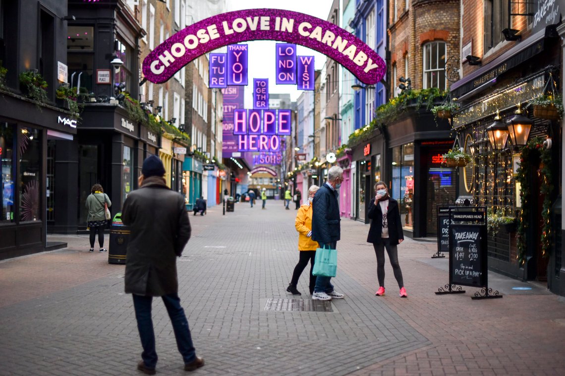 People wear face masks as they walk in a near empty Carnaby Street, in London, Tuesday, Dec. 22, 2020. Britain's Prime Minister Boris Johnson cancelled Christmas for almost 18 million people across London and eastern and south-east England, following warnings from scientists of the rapid spread of the new variant of coronavirus.(AP Photo/Alberto Pezzali) People wear face masks as they walk in a near empty Carnaby Street, in London, Tuesday, Dec. 22, 2020. Britain's Prime Minister Boris Johnson cancelled Christmas for almost 18 million people across London and eastern and south-east England, following warnings from scientists of the rapid spread of the new variant of coronavirus.(AP Photo/Alberto Pezzali)