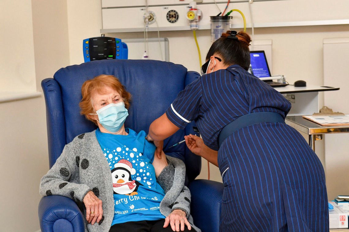 90 year old Margaret Keenan, the first patient in the UK to receive the Pfizer-BioNTech COVID-19 vaccine, administered by nurse May Parsons at University Hospital, Coventry, England, Tuesday Dec. 8, 2020. The United Kingdom, one of the countries hardest hit by the coronavirus, is beginning its vaccination campaign, a key step toward eventually ending the pandemic. (Jacob King/Pool via AP) 90 year old Margaret Keenan, the first patient in the UK to receive the Pfizer-BioNTech COVID-19 vaccine, administered by nurse May Parsons at University Hospital, Coventry, England, Tuesday Dec. 8, 2020. The United Kingdom, one of the countries hardest hit by the coronavirus, is beginning its vaccination campaign, a key step toward eventually ending the pandemic. (Jacob King/Pool via AP)