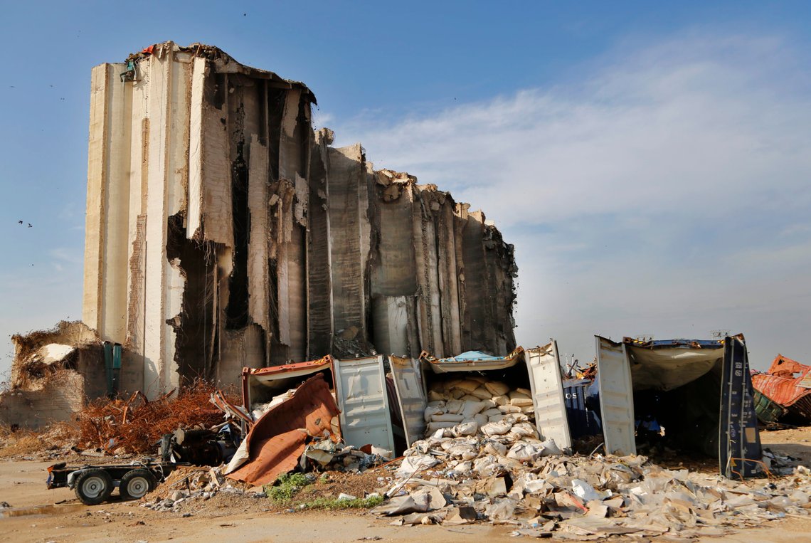 Damaged containers remain in front of towering grain silos gutted in the massive August explosion at the Beirut port that claimed the lives of more than 200 people, in Beirut, Lebanon, Wednesday, Dec. 2, 2020. A heated debate is underway in Lebanon over the fate of the towering silos with some arguing the gutted silos could collapse at any moment, and must be demolished, while others call for the ruins to be preserved as a grim memorial. (AP Photo/Hussein Malla) Damaged containers remain in front of towering grain silos gutted in the massive August explosion at the Beirut port that claimed the lives of more than 200 people, in Beirut, Lebanon, Wednesday, Dec. 2, 2020. A heated debate is underway in Lebanon over the fate of the towering silos with some arguing the gutted silos could collapse at any moment, and must be demolished, while others call for the ruins to be preserved as a grim memorial. (AP Photo/Hussein Malla)
