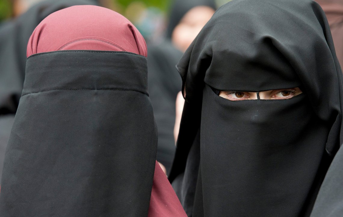 FILE - In this June 28, 2014 file photo veiled women attend a speech by preacher Pierre Vogel, in Offenbach, near Frankfurt, Germany. A law that forbids any kind of full-face covering, including Islamic veils such as the niqab or burqa, has come into force in Austria Sunday, Oct. 1, 2017. Only a small number of Muslim women in Austria wear full-face veils, but they have become a target for right-wing groups and political parties. France and Belgium have similar laws and the nationalist Alternative for Germany party is calling for a burqa ban there too. (Boris Roessler/dpa via AP,file) FILE - In this June 28, 2014 file photo veiled women attend a speech by preacher Pierre Vogel, in Offenbach, near Frankfurt, Germany. A law that forbids any kind of full-face covering, including Islamic veils such as the niqab or burqa, has come into force in Austria Sunday, Oct. 1, 2017. Only a small number of Muslim women in Austria wear full-face veils, but they have become a target for right-wing groups and political parties. France and Belgium have similar laws and the nationalist Alternative for Germany party is calling for a burqa ban there too. (Boris Roessler/dpa via AP,file)