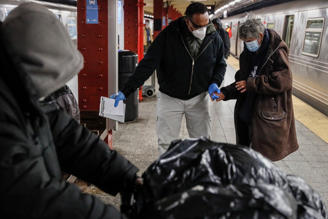 A homeless man is given assistance by a homeless outreach worker in the 207th Street station for the A train, Thursday, April 30, 2020, in the Manhattan borough of New York. Last week, for the first time in New York's history, the trains stopped running in a planned shutdown for a nightly cleaning to disinfect trains. The homeless have borne the brunt of the shutdown as some 2,000 homeless people rely on trains for a warm place to pass the night. Now, at 1 a.m. or soon after, they're met at end-of-the-line stations by police, hundreds of cleaners and a handful of outreach workers who can steer people to shelters or hospitals. (AP Photo/John Minchillo) A homeless man is given assistance by a homeless outreach worker in the 207th Street station for the A train, Thursday, April 30, 2020, in the Manhattan borough of New York. Last week, for the first time in New York's history, the trains stopped running in a planned shutdown for a nightly cleaning to disinfect trains. The homeless have borne the brunt of the shutdown as some 2,000 homeless people rely on trains for a warm place to pass the night. Now, at 1 a.m. or soon after, they're met at end-of-the-line stations by police, hundreds of cleaners and a handful of outreach workers who can steer people to shelters or hospitals. (AP Photo/John Minchillo)
