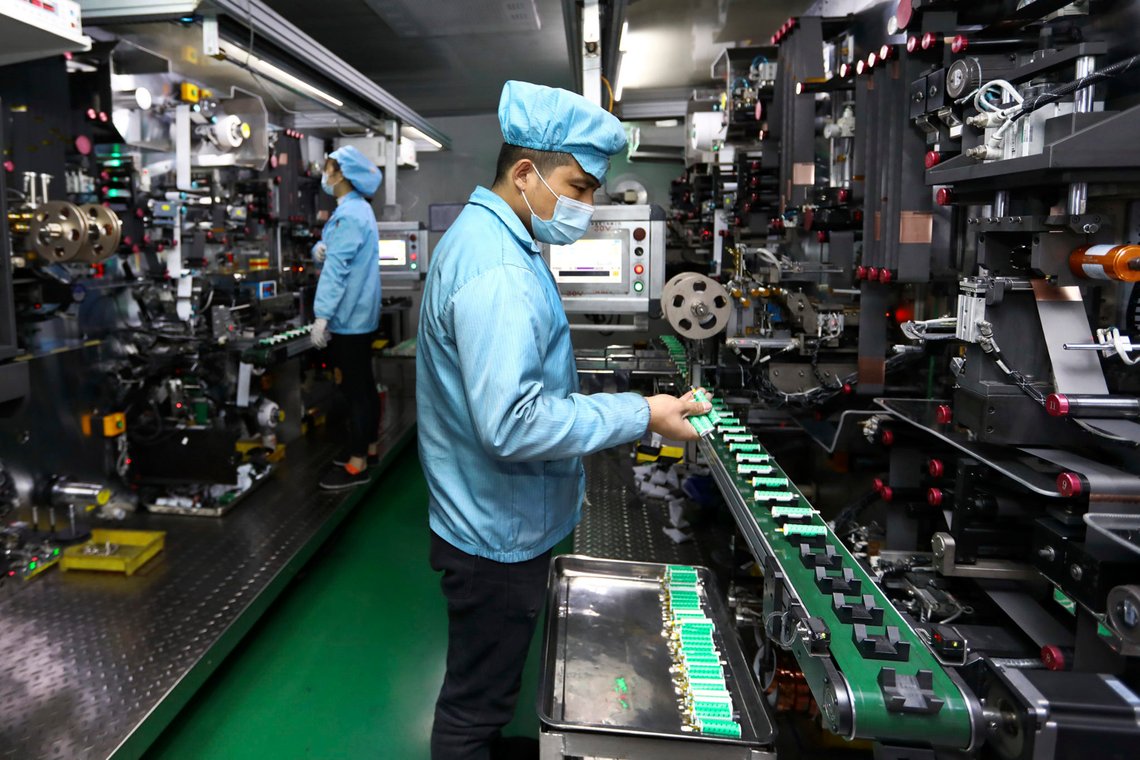 Workers place batteries on a machine at a factory manufacturing lithium batteries in Huaibei in central China's Anhui province on Nov. 14, 2020. China's manufacturing activity accelerated in November as its rebound from the pandemic gained strength, a survey showed Monday, Nov. 30, 2020, while the United States and Europe struggled with rising infections and renewed controls on business. (Chinatopix via AP) Workers place batteries on a machine at a factory manufacturing lithium batteries in Huaibei in central China's Anhui province on Nov. 14, 2020. China's manufacturing activity accelerated in November as its rebound from the pandemic gained strength, a survey showed Monday, Nov. 30, 2020, while the United States and Europe struggled with rising infections and renewed controls on business. (Chinatopix via AP)