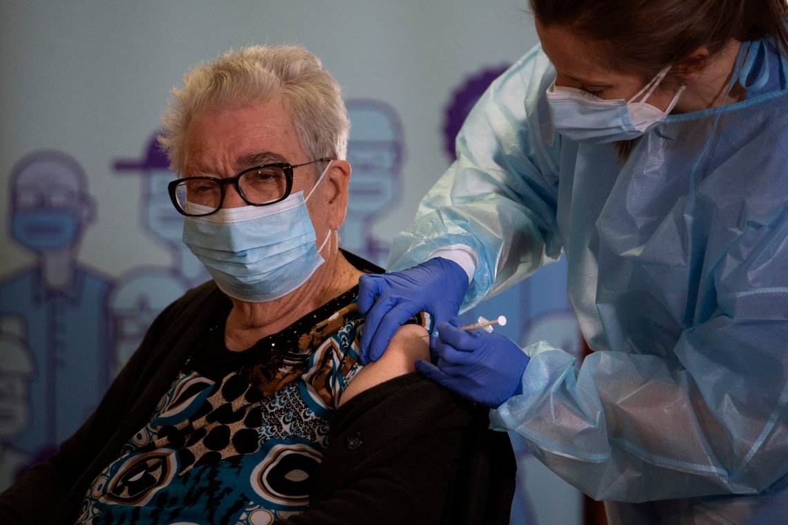 Josefa Perez, 89, is vaccinated against the Corona virus at a nursing home in l'Hospitalet de Llobregat in Barcelona, Spain, on Sunday, Dec. 27, 2020. The first shipments of coronavirus vaccines developed by BioNTech and Pfizer have arrived across the European Union, authorities started to vaccinate the most vulnerable people in a coordinated effort on Sunday. (AP Photo/Emilio Morenatti) Josefa Perez, 89, is vaccinated against the Corona virus at a nursing home in l'Hospitalet de Llobregat in Barcelona, Spain, on Sunday, Dec. 27, 2020. The first shipments of coronavirus vaccines developed by BioNTech and Pfizer have arrived across the European Union, authorities started to vaccinate the most vulnerable people in a coordinated effort on Sunday. (AP Photo/Emilio Morenatti)