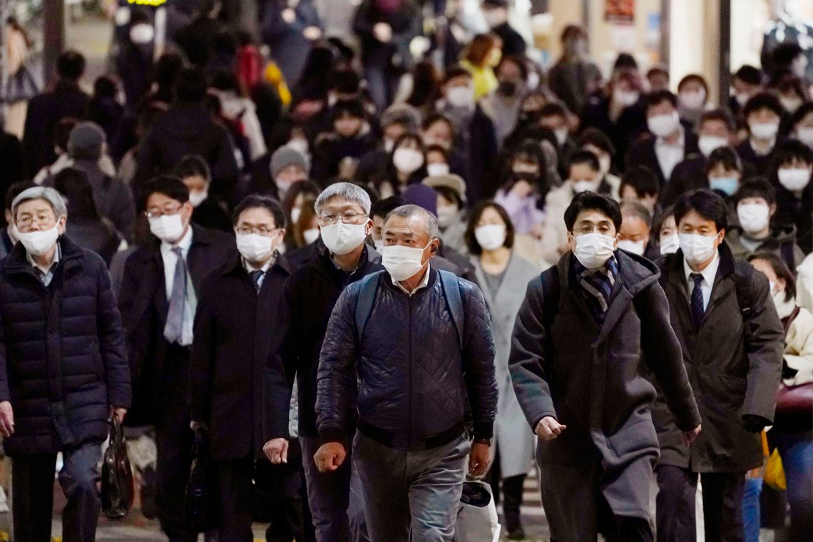 People wearing face masks to protect against the coronavirus make their way toward a station in Tokyo Monday, Dec. 21, 2020. Daily coronavirus cases have been steadily on the rise nationwide. Tokyo Gov. Yuriko Koike on Monday asked all residents to celebrate Christmas and New Year at home just with their families, and asked organizers to light-up events to close early in the night. (Kenzaburo Fukuhara/Kyodo News via AP) People wearing face masks to protect against the coronavirus make their way toward a station in Tokyo Monday, Dec. 21, 2020. Daily coronavirus cases have been steadily on the rise nationwide. Tokyo Gov. Yuriko Koike on Monday asked all residents to celebrate Christmas and New Year at home just with their families, and asked organizers to light-up events to close early in the night. (Kenzaburo Fukuhara/Kyodo News via AP)