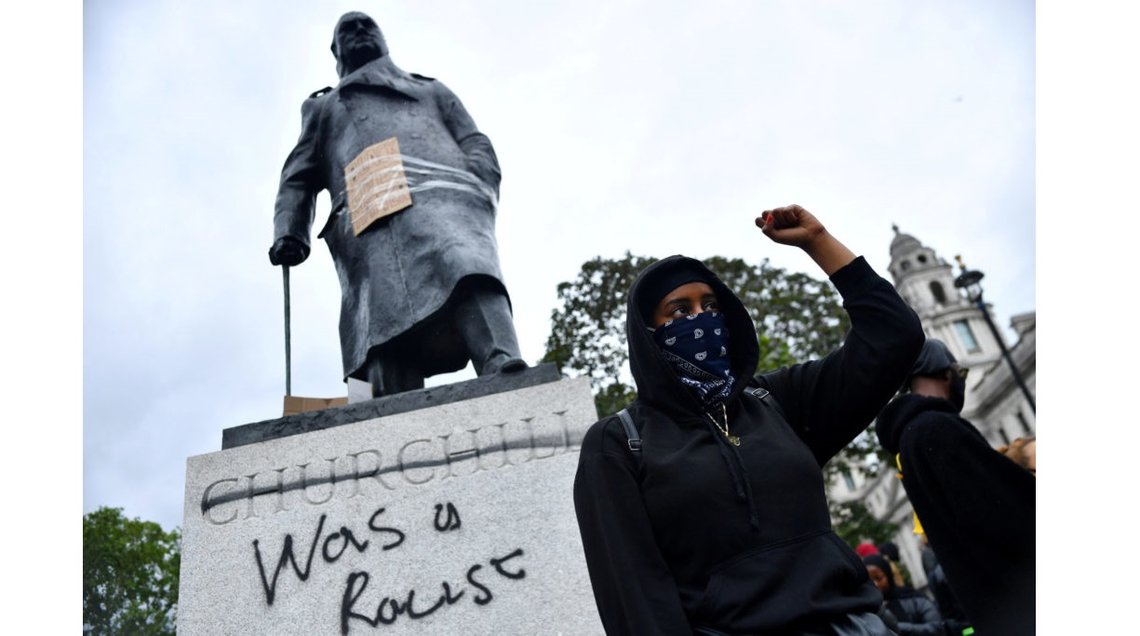 FILE PHOTO: A demonstrator reacts infront of graffiti on a statue of Winston Churchill in Parliament Square during a Black Lives Matter protest in London, following the death of George Floyd who died in police custody in Minneapolis, London, Britain, June 7, 2020. REUTERS/Dylan Martinez TPX IMAGES OF THE DAY - RC2G4H9061BN/File Photo FILE PHOTO: A demonstrator reacts infront of graffiti on a statue of Winston Churchill in Parliament Square during a Black Lives Matter protest in London, following the death of George Floyd who died in police custody in Minneapolis, London, Britain, June 7, 2020. REUTERS/Dylan Martinez TPX IMAGES OF THE DAY - RC2G4H9061BN/File Photo