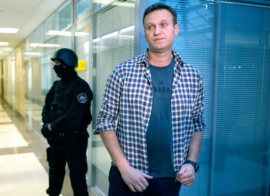 FILE - In this Dec. 26, 2019 file photo, Russian opposition leader Alexei Navalny speaks to the media in front of a security officer standing guard at the Foundation for Fighting Corruption office in Moscow, Russia. Navalny was jailed soon after arriving to Moscow after authorities accused him of violating of the terms of his 2014 fraud conviction. A court on Thursday Jan. 28, 2021, is to hear an appeal on the ruling to remand him into custody. Next week, another court will decide whether to send him to prison for several years for the alleged violations. (AP Photo/Alexander Zemlianichenko, File) FILE - In this Dec. 26, 2019 file photo, Russian opposition leader Alexei Navalny speaks to the media in front of a security officer standing guard at the Foundation for Fighting Corruption office in Moscow, Russia. Navalny was jailed soon after arriving to Moscow after authorities accused him of violating of the terms of his 2014 fraud conviction. A court on Thursday Jan. 28, 2021, is to hear an appeal on the ruling to remand him into custody. Next week, another court will decide whether to send him to prison for several years for the alleged violations. (AP Photo/Alexander Zemlianichenko, File)