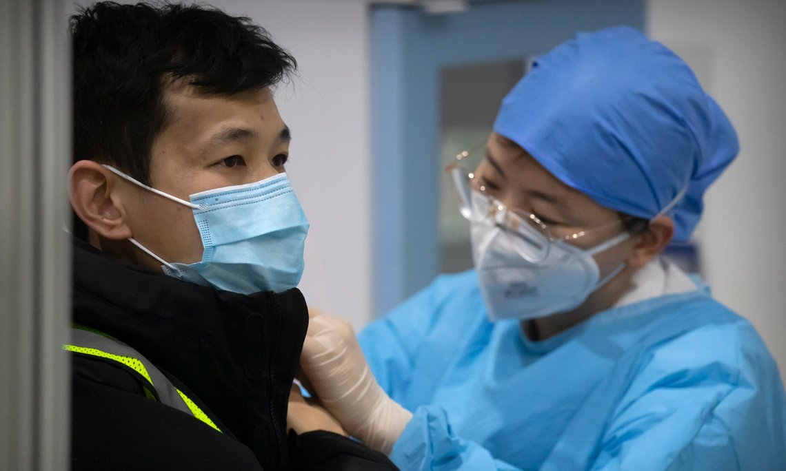 A medical worker gives a coronavirus vaccine shot to a patient at a vaccination facility in Beijing, Friday, Jan. 15, 2021. A city in northern China is building a 3,000-unit quarantine facility to deal with an anticipated overflow of patients as COVID-19 cases rise ahead of the Lunar New Year travel rush. (AP Photo/Mark Schiefelbein) A medical worker gives a coronavirus vaccine shot to a patient at a vaccination facility in Beijing, Friday, Jan. 15, 2021. A city in northern China is building a 3,000-unit quarantine facility to deal with an anticipated overflow of patients as COVID-19 cases rise ahead of the Lunar New Year travel rush. (AP Photo/Mark Schiefelbein)