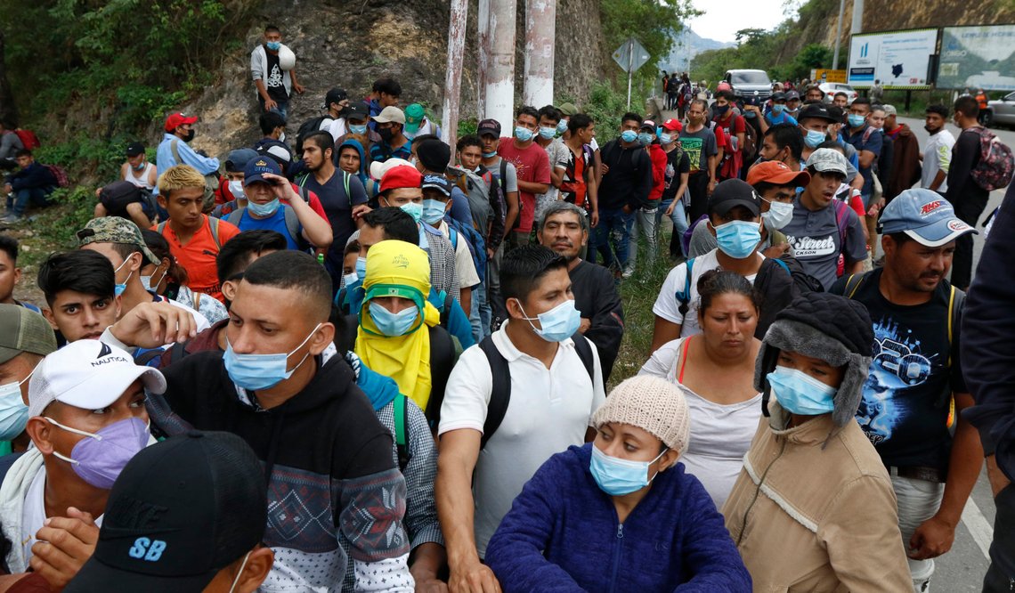 Migrants hoping to reach the U.S. border wait to receive food from volunteers, in Chiquimula, Guatemala, Saturday, Jan. 16, 2021. Honduran migrants pushed their way into Guatemala Friday night without registering, a portion of a larger migrant caravan that had left the Honduran city of San Pedro Sula before dawn, Guatemalan authorities said. (AP Photo/Delmer Martinez) Migrants hoping to reach the U.S. border wait to receive food from volunteers, in Chiquimula, Guatemala, Saturday, Jan. 16, 2021. Honduran migrants pushed their way into Guatemala Friday night without registering, a portion of a larger migrant caravan that had left the Honduran city of San Pedro Sula before dawn, Guatemalan authorities said. (AP Photo/Delmer Martinez)