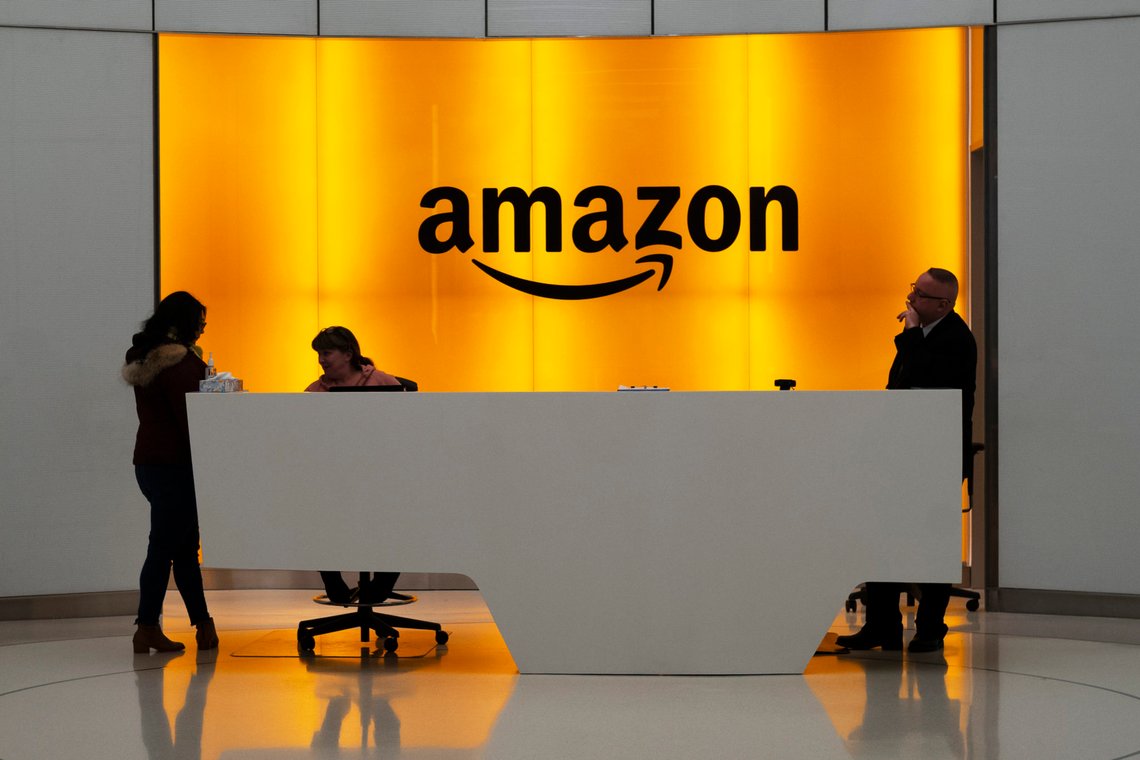 FILE - In this Feb. 14, 2019 file photo, people stand in the lobby for Amazon offices in New York. Amazon is jumping into the podcast-making business. The online shopping giant said it plans to buy Wondery, a 4-year-old producer of popular true crime podcasts such as Dr. Death and Dirty John. (AP Photo/Mark Lennihan, File) FILE - In this Feb. 14, 2019 file photo, people stand in the lobby for Amazon offices in New York. Amazon is jumping into the podcast-making business. The online shopping giant said it plans to buy Wondery, a 4-year-old producer of popular true crime podcasts such as Dr. Death and Dirty John. (AP Photo/Mark Lennihan, File)