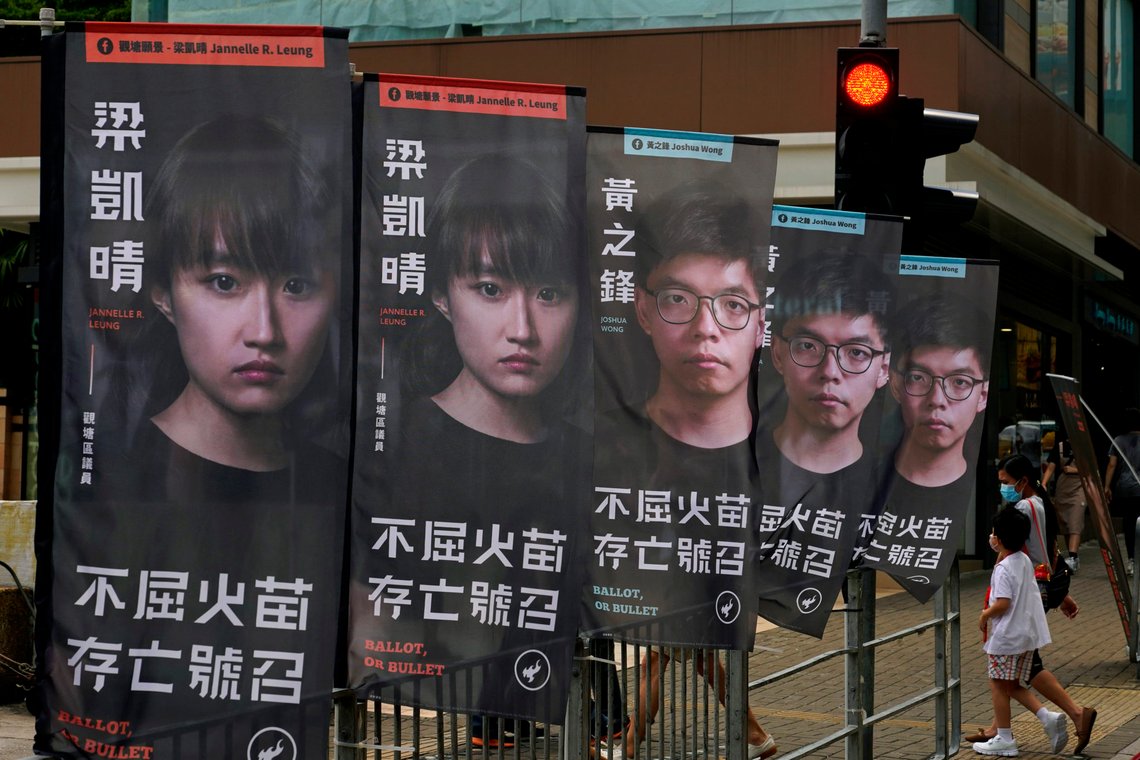 FILE - In this July 11, 2020, file photo, banners of a pro-democracy candidate Joshua Wong, wearing glasses, are displayed outside a subway station in Hong Kong, in an unofficial primary for pro-democracy candidates ahead of legislative elections. About 50 Hong Kong pro-democracy figures were arrested by police on Wednesday, Jan. 6, 2021 under a national security law, following their involvement in an unofficial primary election last year held to increase their chances of controlling the legislature, according to local media reports. (AP Photo/Vincent Yu,File) FILE - In this July 11, 2020, file photo, banners of a pro-democracy candidate Joshua Wong, wearing glasses, are displayed outside a subway station in Hong Kong, in an unofficial primary for pro-democracy candidates ahead of legislative elections. About 50 Hong Kong pro-democracy figures were arrested by police on Wednesday, Jan. 6, 2021 under a national security law, following their involvement in an unofficial primary election last year held to increase their chances of controlling the legislature, according to local media reports. (AP Photo/Vincent Yu,File)