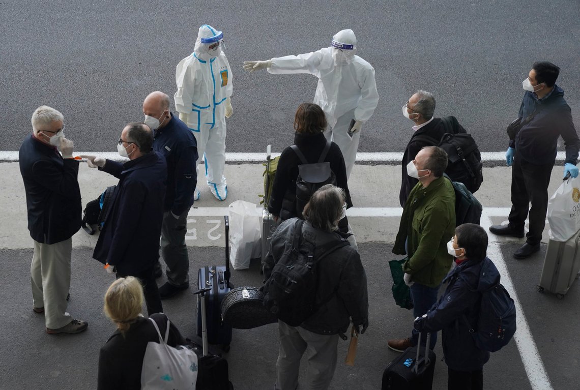 A worker in protective coverings directs members of the World Health Organization (WHO) team on their arrival at the airport in Wuhan in central China's Hubei province on Thursday, Jan. 14, 2021. A global team of researchers arrived Thursday in the Chinese city where the coronavirus pandemic was first detected to conduct a politically sensitive investigation into its origins amid uncertainty about whether Beijing might try to prevent embarrassing discoveries. (AP Photo/Ng Han Guan) A worker in protective coverings directs members of the World Health Organization (WHO) team on their arrival at the airport in Wuhan in central China's Hubei province on Thursday, Jan. 14, 2021. A global team of researchers arrived Thursday in the Chinese city where the coronavirus pandemic was first detected to conduct a politically sensitive investigation into its origins amid uncertainty about whether Beijing might try to prevent embarrassing discoveries. (AP Photo/Ng Han Guan)