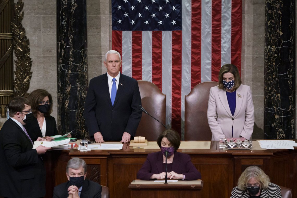 Vice President Mike Pence and Speaker of the House Nancy Pelosi, D-Calif., read the final certification of Electoral College votes cast in November's presidential election during a joint session of Congress after working through the night, at the Capitol in Washington, Thursday, Jan. 7, 2021. Violent protesters loyal to President Donald Trump stormed the Capitol Wednesday, disrupting the process. (AP Photo/J. Scott Applewhite, Pool) Vice President Mike Pence and Speaker of the House Nancy Pelosi, D-Calif., read the final certification of Electoral College votes cast in November's presidential election during a joint session of Congress after working through the night, at the Capitol in Washington, Thursday, Jan. 7, 2021. Violent protesters loyal to President Donald Trump stormed the Capitol Wednesday, disrupting the process. (AP Photo/J. Scott Applewhite, Pool)