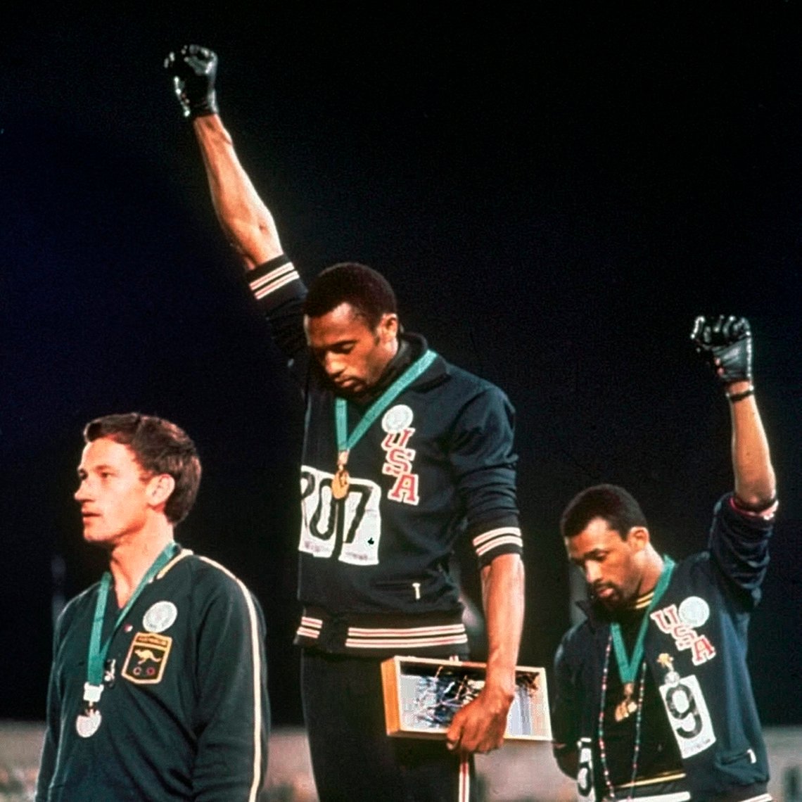 FILE - In this Oct. 16, 1968, file photo, U.S. athletes Tommie Smith, center, and John Carlos extend gloved hands skyward in racial protest during the playing of national anthem after Smith received the gold and Carlos the bronze for the 200 meter run at the Summer Olympic Games in Mexico City. Australian silver medalist Peter Norman is at left. The U.S. Olympic and Paralympic Committee heeded calls from American athletes, announcing Thursday, Dec. 10, 2020, that it wont sanction them for raising their fists or kneeling on the medals stand at next years Tokyo Games and beyond. (AP Photo/File) FILE - In this Oct. 16, 1968, file photo, U.S. athletes Tommie Smith, center, and John Carlos extend gloved hands skyward in racial protest during the playing of national anthem after Smith received the gold and Carlos the bronze for the 200 meter run at the Summer Olympic Games in Mexico City. Australian silver medalist Peter Norman is at left. The U.S. Olympic and Paralympic Committee heeded calls from American athletes, announcing Thursday, Dec. 10, 2020, that it wont sanction them for raising their fists or kneeling on the medals stand at next years Tokyo Games and beyond. (AP Photo/File)
