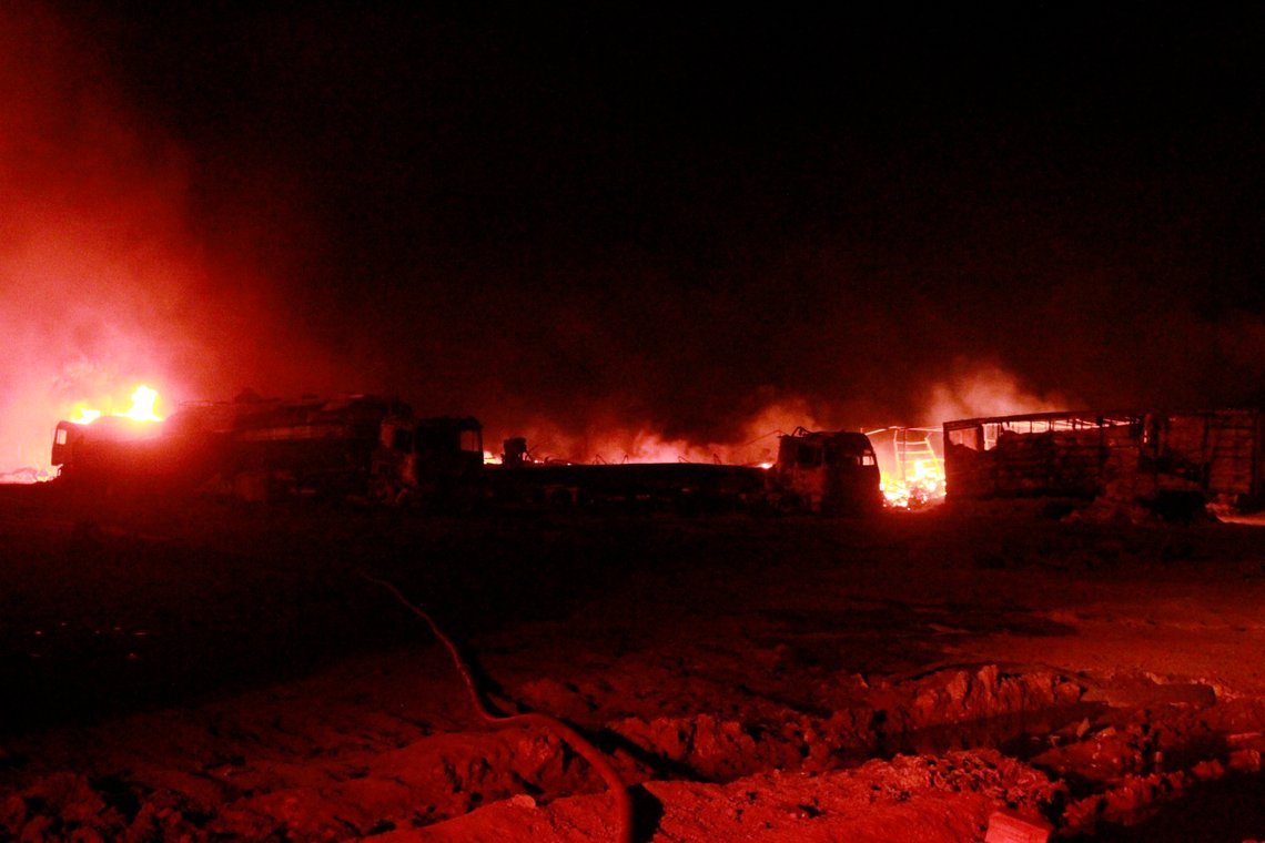 A fire of a burning oil tanker is seen where firefighters try to extinguish after an explosion at the Islam Qala border with Iran, in Herat Province, west of Kabul, Afghanistan, Saturday, Feb. 13, 2021. The fuel tanker exploded Saturday at the Islam Qala crossing in Afghanistan's western Herat province on the Iranian border, injuring multiple people and causing the massive fire that consumed more than 500 trucks carrying natural gas and fuel, according to Afghan officials and Iranian state media. (AP Photo/Hamed Sarfarazi) A fire of a burning oil tanker is seen where firefighters try to extinguish after an explosion at the Islam Qala border with Iran, in Herat Province, west of Kabul, Afghanistan, Saturday, Feb. 13, 2021. The fuel tanker exploded Saturday at the Islam Qala crossing in Afghanistan's western Herat province on the Iranian border, injuring multiple people and causing the massive fire that consumed more than 500 trucks carrying natural gas and fuel, according to Afghan officials and Iranian state media. (AP Photo/Hamed Sarfarazi)