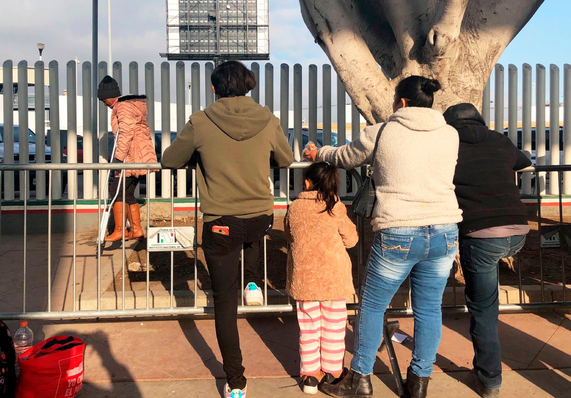 In this Wednesday, Jan. 8, 2020, photo, people seeking asylum in the United States wait at the border crossing bridge in Tijuana, Mexico, just across the border from San Diego. The number of people arrested or stopped entering the U.S. along the Mexico border fell for a seventh straight month in December, with Mexicans making up a larger than usual part of the mix, authorities said Thursday. (AP Photo/Elliot Spagat) In this Wednesday, Jan. 8, 2020, photo, people seeking asylum in the United States wait at the border crossing bridge in Tijuana, Mexico, just across the border from San Diego. The number of people arrested or stopped entering the U.S. along the Mexico border fell for a seventh straight month in December, with Mexicans making up a larger than usual part of the mix, authorities said Thursday. (AP Photo/Elliot Spagat)