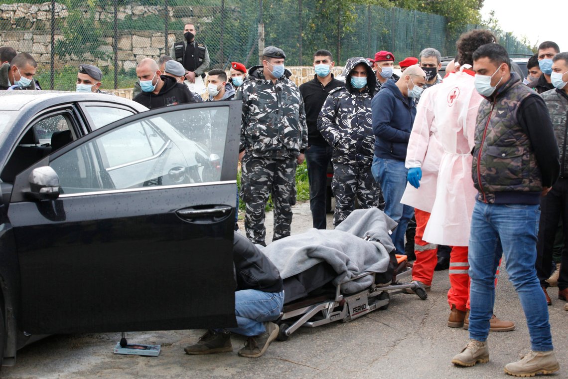 Body of Lokman Slim, a longtime Shiite political activist and researcher, who has been found dead in his car, lies on the ground as Lebanese security forces inspect the scene in Addoussieh village, in the southern province of Nabatiyeh, Lebanon, Thursday, Feb. 4, 2021. (AP Photo/Mohammed Zaatari) Body of Lokman Slim, a longtime Shiite political activist and researcher, who has been found dead in his car, lies on the ground as Lebanese security forces inspect the scene in Addoussieh village, in the southern province of Nabatiyeh, Lebanon, Thursday, Feb. 4, 2021. (AP Photo/Mohammed Zaatari)