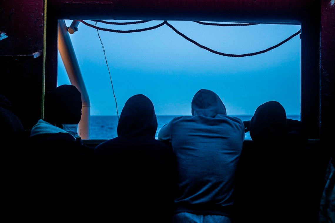 Migrants stand on the deck of the Ocean Viking rescue ship, in the Mediterranean Sea on Sunday, Feb. 7, 2021. A rescue ship with 422 migrants aboard, some of whom tested positive for COVID-19, is heading to Sicily. SOS Mediterranee, the humanitarian group which operates the rescue ship Ocean Viking, told The AP on Sunday that Italy granted the vessel permission to enter the port of Augusta. (Hippolyte/SOS Mediterranee via AP) Migrants stand on the deck of the Ocean Viking rescue ship, in the Mediterranean Sea on Sunday, Feb. 7, 2021. A rescue ship with 422 migrants aboard, some of whom tested positive for COVID-19, is heading to Sicily. SOS Mediterranee, the humanitarian group which operates the rescue ship Ocean Viking, told The AP on Sunday that Italy granted the vessel permission to enter the port of Augusta. (Hippolyte/SOS Mediterranee via AP)