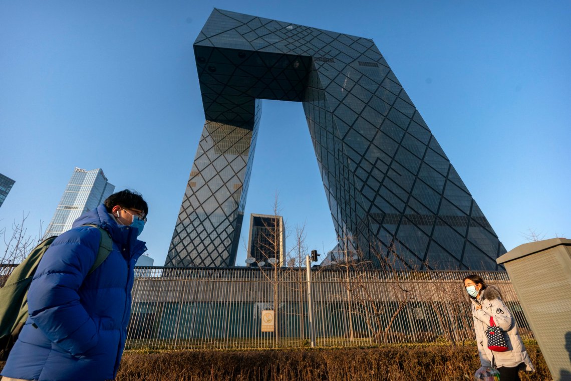 FILE- In this Thursday, Feb. 4, 2021 file photo, people wearing face masks to protect against the spread of the coronavirus, walk past the CCTV Headquarters building, the home of Chinese state-run television network CCTV and its overseas arm CGTN, in Beijing. The U.K. has stripped China's state-owned TV channel of its broadcasting license in the country, after an investigation found the license holder lacked editorial control and had links to China's ruling Communist Party. (AP Photo/Mark Schiefelbein, File) FILE- In this Thursday, Feb. 4, 2021 file photo, people wearing face masks to protect against the spread of the coronavirus, walk past the CCTV Headquarters building, the home of Chinese state-run television network CCTV and its overseas arm CGTN, in Beijing. The U.K. has stripped China's state-owned TV channel of its broadcasting license in the country, after an investigation found the license holder lacked editorial control and had links to China's ruling Communist Party. (AP Photo/Mark Schiefelbein, File)