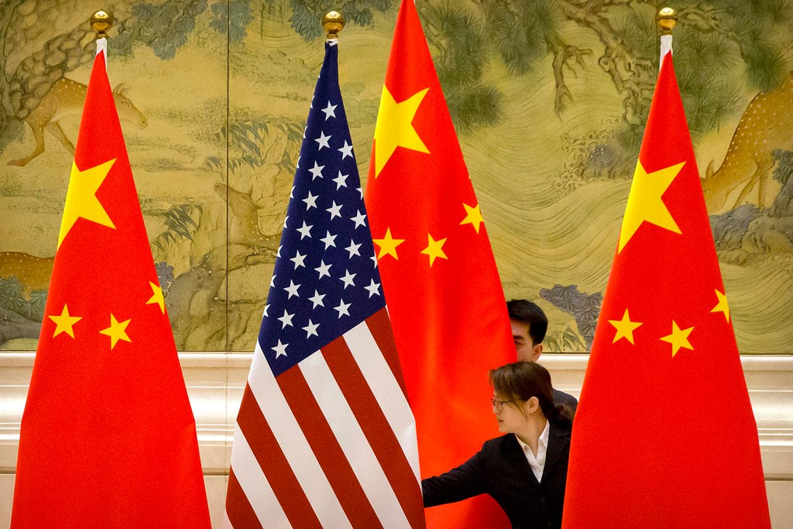 FILE - In this Feb. 14, 2019 file photo, Chinese staffers adjust the U.S. and Chinese flags before the opening session of trade negotiations between U.S. and Chinese trade representatives at the Diaoyutai State Guesthouse in Beijing. New polling from the Pew Research Center shows strong negative attitudes among Americans toward China, with almost nine out of 10 adults seeing the country as hostile or a danger to U.S. interests. (AP Photo/Mark Schiefelbein, File) FILE - In this Feb. 14, 2019 file photo, Chinese staffers adjust the U.S. and Chinese flags before the opening session of trade negotiations between U.S. and Chinese trade representatives at the Diaoyutai State Guesthouse in Beijing. New polling from the Pew Research Center shows strong negative attitudes among Americans toward China, with almost nine out of 10 adults seeing the country as hostile or a danger to U.S. interests. (AP Photo/Mark Schiefelbein, File)