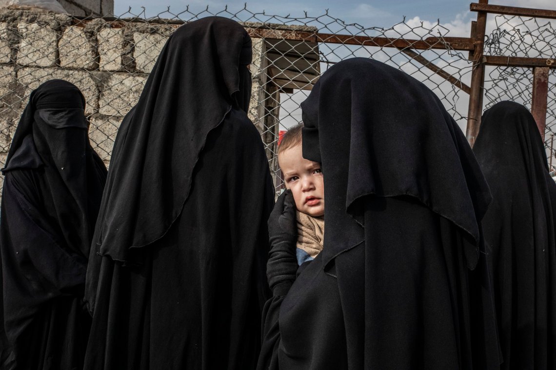 This image released by World Press Photo, Thursday April 16, 2020, by Alessio Mamo for L'Espresso, which won second prize in the General News Singles category, A Russian woman carries her child while queuing at a makeshift hospital in 'The Annex', at Al-Hol Refugee Camp in northern Syria, on 14 November 2019. (Alessio Mamo for L'Espresso, World Press Photo via AP) This image released by World Press Photo, Thursday April 16, 2020, by Alessio Mamo for L'Espresso, which won second prize in the General News Singles category, A Russian woman carries her child while queuing at a makeshift hospital in 'The Annex', at Al-Hol Refugee Camp in northern Syria, on 14 November 2019. (Alessio Mamo for L'Espresso, World Press Photo via AP)