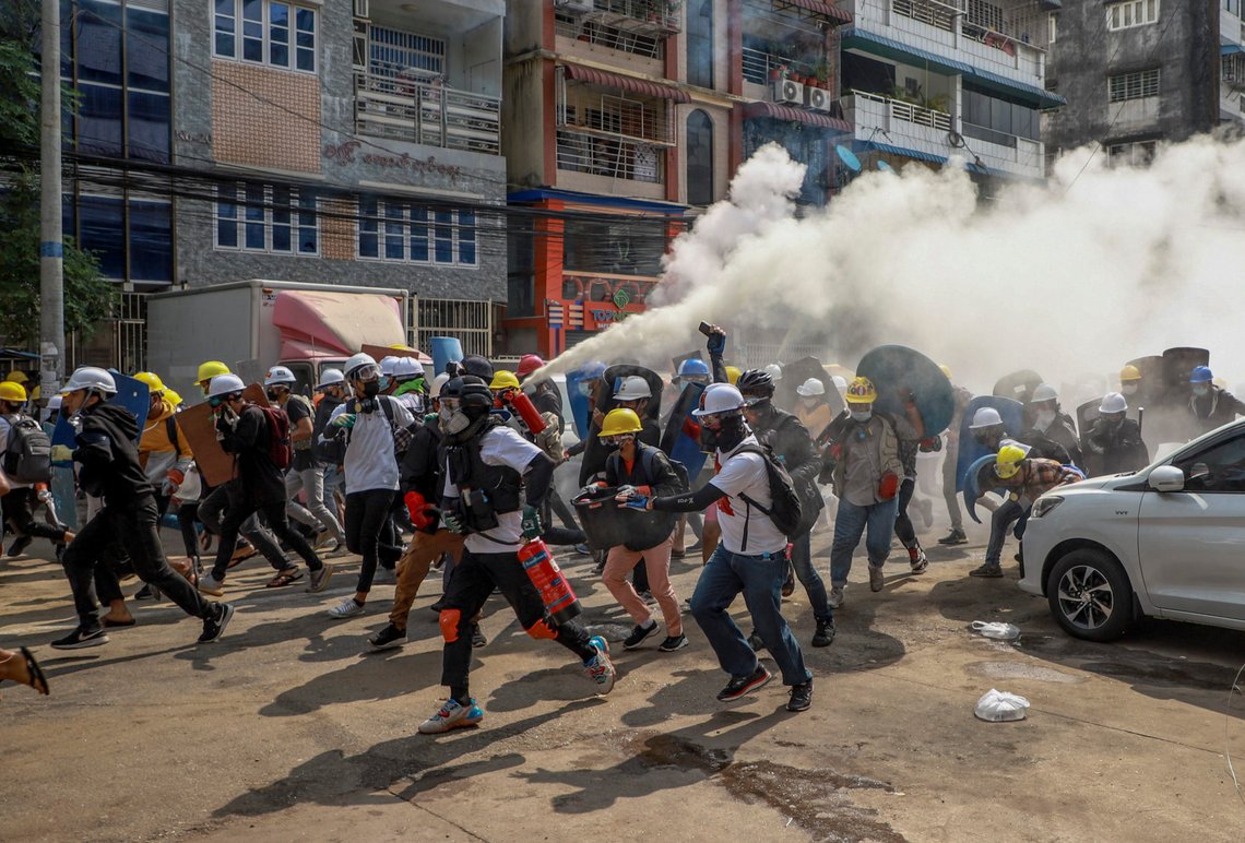 Anti-coup protesters run as one of them discharges a fire extinguisher to counter the impact of tear gas fired by riot policemen in Yangon, Myanmar, Wednesday, March 3, 2021. Demonstrators in Myanmar took to the streets again on Wednesday to protest last month's seizure of power by the military. (AP Photo) Anti-coup protesters run as one of them discharges a fire extinguisher to counter the impact of tear gas fired by riot policemen in Yangon, Myanmar, Wednesday, March 3, 2021. Demonstrators in Myanmar took to the streets again on Wednesday to protest last month's seizure of power by the military. (AP Photo)