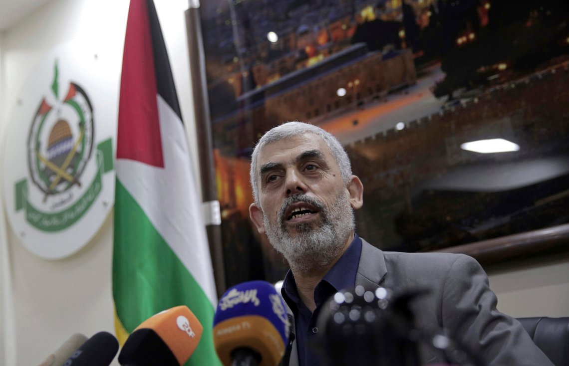 FILE - IN this May 10, 2018 file photo, Yehiyeh Sinwar, the Hamas militant group's leader in the Gaza Strip, speaks to foreign correspondents, in his office in Gaza City. Hamas is holding a leadership election in its Gaza Strip stronghold. The race has deep implications for its relations with Israel and other regional players. A Hamas official said the field had narrowed down to a tight race between Sinwar, the groups current firebrand leader, and Nizar Awadallah, a co-founder of the movement. (AP Photo/Khalil Hamra, File) FILE - IN this May 10, 2018 file photo, Yehiyeh Sinwar, the Hamas militant group's leader in the Gaza Strip, speaks to foreign correspondents, in his office in Gaza City. Hamas is holding a leadership election in its Gaza Strip stronghold. The race has deep implications for its relations with Israel and other regional players. A Hamas official said the field had narrowed down to a tight race between Sinwar, the groups current firebrand leader, and Nizar Awadallah, a co-founder of the movement. (AP Photo/Khalil Hamra, File)