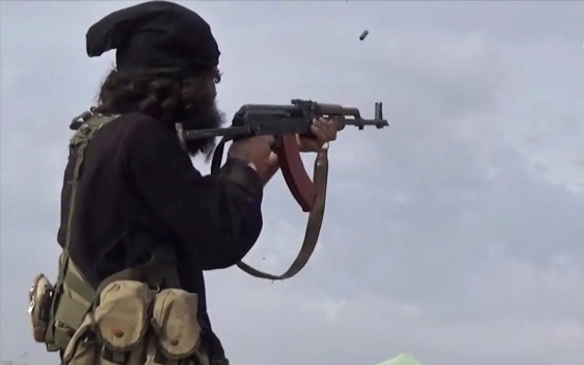 FILE - This file frame grab from video posted online March 18, 2019, by the Aamaq News Agency, a media arm of the Islamic State group, shows an IS fighter firing his weapon during clashes with the U.S.-backed Syrian Democratic Forces (SDF) fighters, in Baghouz, Syria. The IS erupted from the chaos of Syria and Iraq's conflicts and swiftly did what no Islamic militant group had done before, conquering a giant stretch of territory and declaring itself a "caliphate." U.S. officials said late Saturday, Oct. 26, 2019 that their shadowy leader Abu Bakr al-Baghdadi was the target of an American raid in Syria and may have died in an explosion. (Aamaq News Agency via AP, File) FILE - This file frame grab from video posted online March 18, 2019, by the Aamaq News Agency, a media arm of the Islamic State group, shows an IS fighter firing his weapon during clashes with the U.S.-backed Syrian Democratic Forces (SDF) fighters, in Baghouz, Syria. The IS erupted from the chaos of Syria and Iraq's conflicts and swiftly did what no Islamic militant group had done before, conquering a giant stretch of territory and declaring itself a "caliphate." U.S. officials said late Saturday, Oct. 26, 2019 that their shadowy leader Abu Bakr al-Baghdadi was the target of an American raid in Syria and may have died in an explosion. (Aamaq News Agency via AP, File)