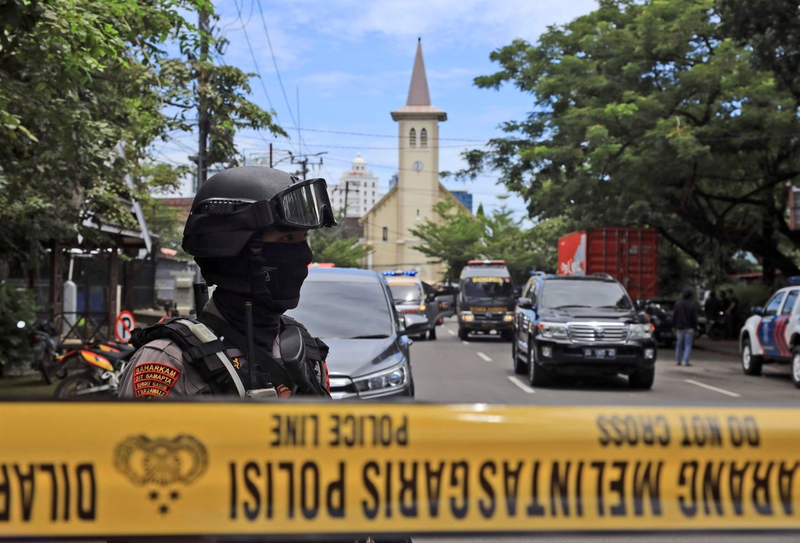 A police officer stands guard near a church where an explosion went off in Makassar, South Sulawesi, Indonesia, Sunday, March 28, 2021. (AP Photo/Yusuf Wahil) A police officer stands guard near a church where an explosion went off in Makassar, South Sulawesi, Indonesia, Sunday, March 28, 2021. (AP Photo/Yusuf Wahil)