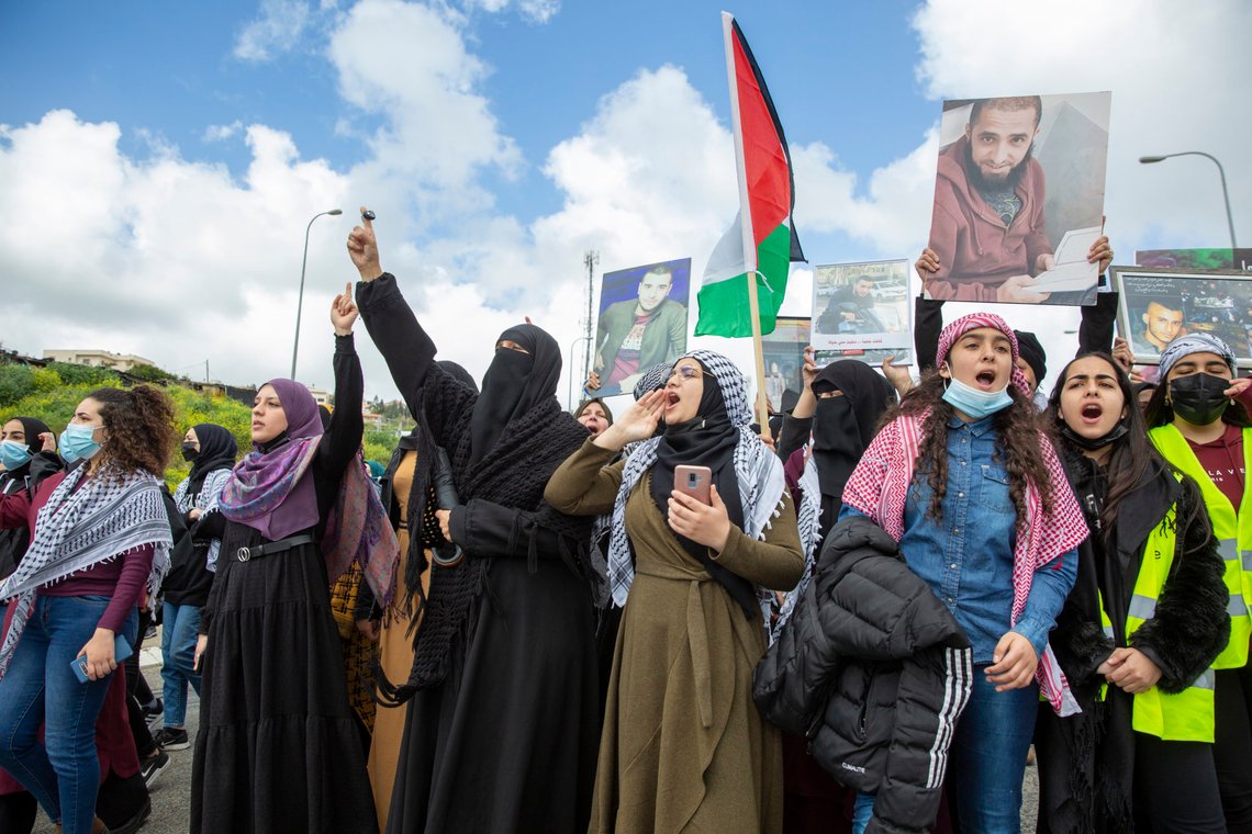 Muslim women shout slogans during a protest against the lack of enforcement by Israel's police and the recent rise in violence in Arab communities in the northern Arab Israeli town of Umm el-Fahm, Israel, Friday, March 12, 2021. (AP Photo/Ariel Schalit) Muslim women shout slogans during a protest against the lack of enforcement by Israel's police and the recent rise in violence in Arab communities in the northern Arab Israeli town of Umm el-Fahm, Israel, Friday, March 12, 2021. (AP Photo/Ariel Schalit)