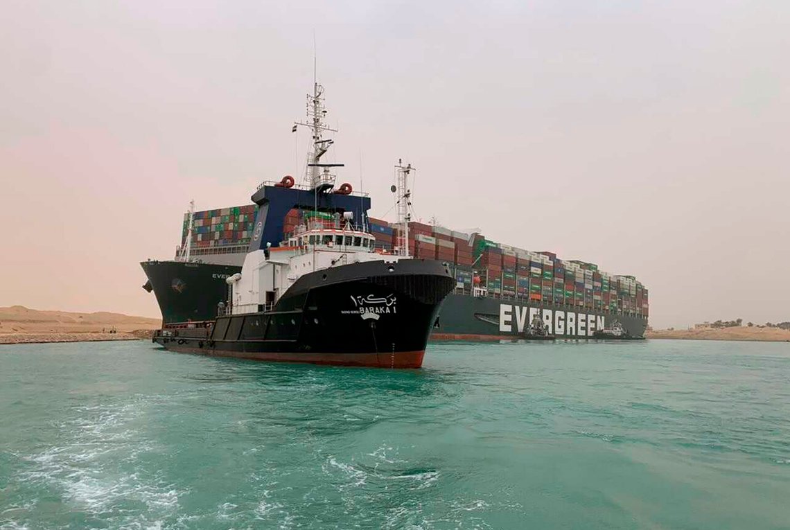 CORRECTS NAME OF SHIP TO EVER GIVEN, NOT EVER GREEN - In this photo released by the Suez Canal Authority, a boat navigates in front of a cargo ship, Ever Given, Wednesday, March 24, 2021, after it become wedged across Egypts Suez Canal and blocked all traffic in the vital waterway. An Egyptian official warned Wednesday it could take at least two days to clear the ship. (Suez Canal Authority via AP) CORRECTS NAME OF SHIP TO EVER GIVEN, NOT EVER GREEN - In this photo released by the Suez Canal Authority, a boat navigates in front of a cargo ship, Ever Given, Wednesday, March 24, 2021, after it become wedged across Egypts Suez Canal and blocked all traffic in the vital waterway. An Egyptian official warned Wednesday it could take at least two days to clear the ship. (Suez Canal Authority via AP)