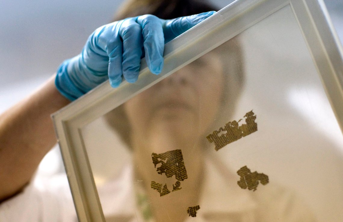 Lena Libman, a worker of the Dead Sea Scrolls conservation laboratory at the IAA, Israel Antiquities Authority, holds a frame with small fragments of the Dead Sea Scrolls in a laboratory in Jerusalem, Tuesday, Oct. 19, 2010. Israel's Antiquities Authority and Google announced Tuesday they are joining forces to bring the Dead Sea Scrolls online, allowing both scholars and the general public widespread access to the ancient manuscripts for the first time. (AP Photo/Sebastian Scheiner) Lena Libman, a worker of the Dead Sea Scrolls conservation laboratory at the IAA, Israel Antiquities Authority, holds a frame with small fragments of the Dead Sea Scrolls in a laboratory in Jerusalem, Tuesday, Oct. 19, 2010. Israel's Antiquities Authority and Google announced Tuesday they are joining forces to bring the Dead Sea Scrolls online, allowing both scholars and the general public widespread access to the ancient manuscripts for the first time. (AP Photo/Sebastian Scheiner)